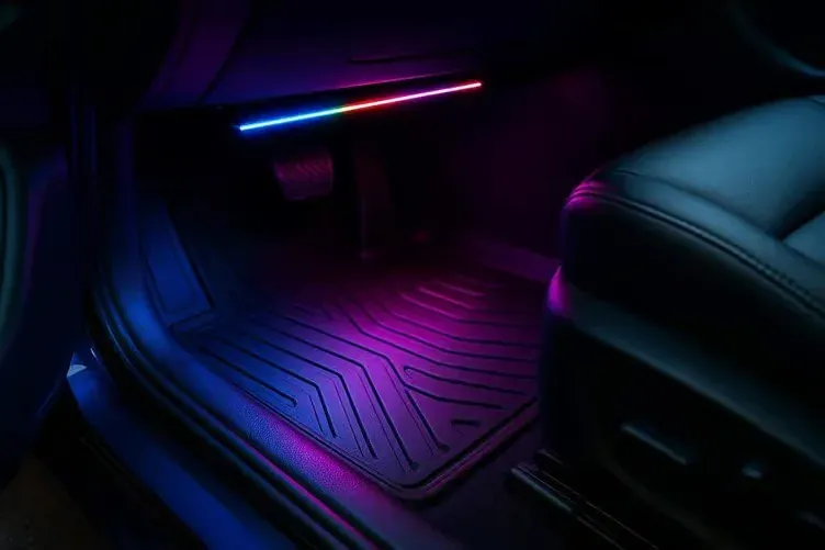 Footwell lighting washing the floor mat in front of the passenger seat