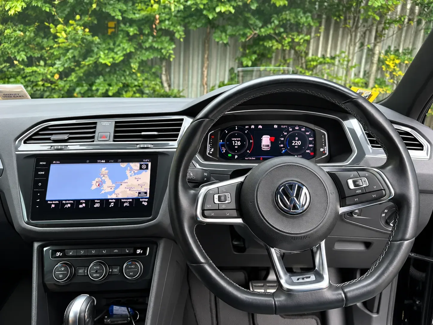 Factory VW Tiguan MIB2 navigation menu on the Discover Media screen with the R-Line steering wheel