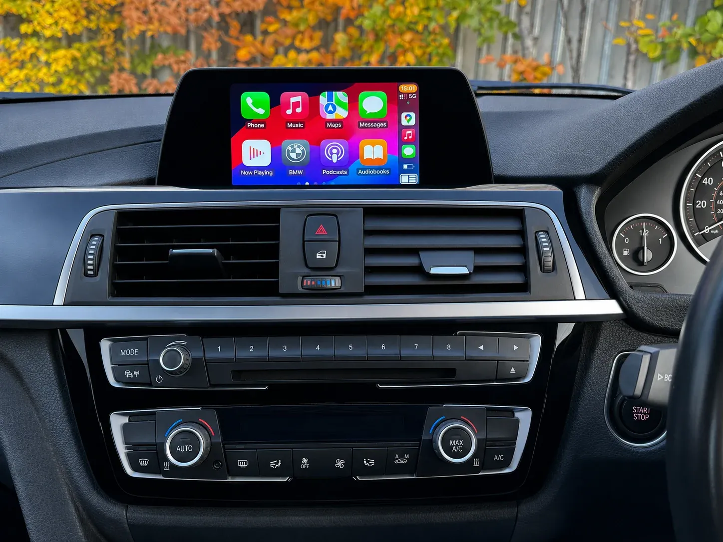 Apple CarPlay running on the same BMW factory screen after activation, dashboard unchanged