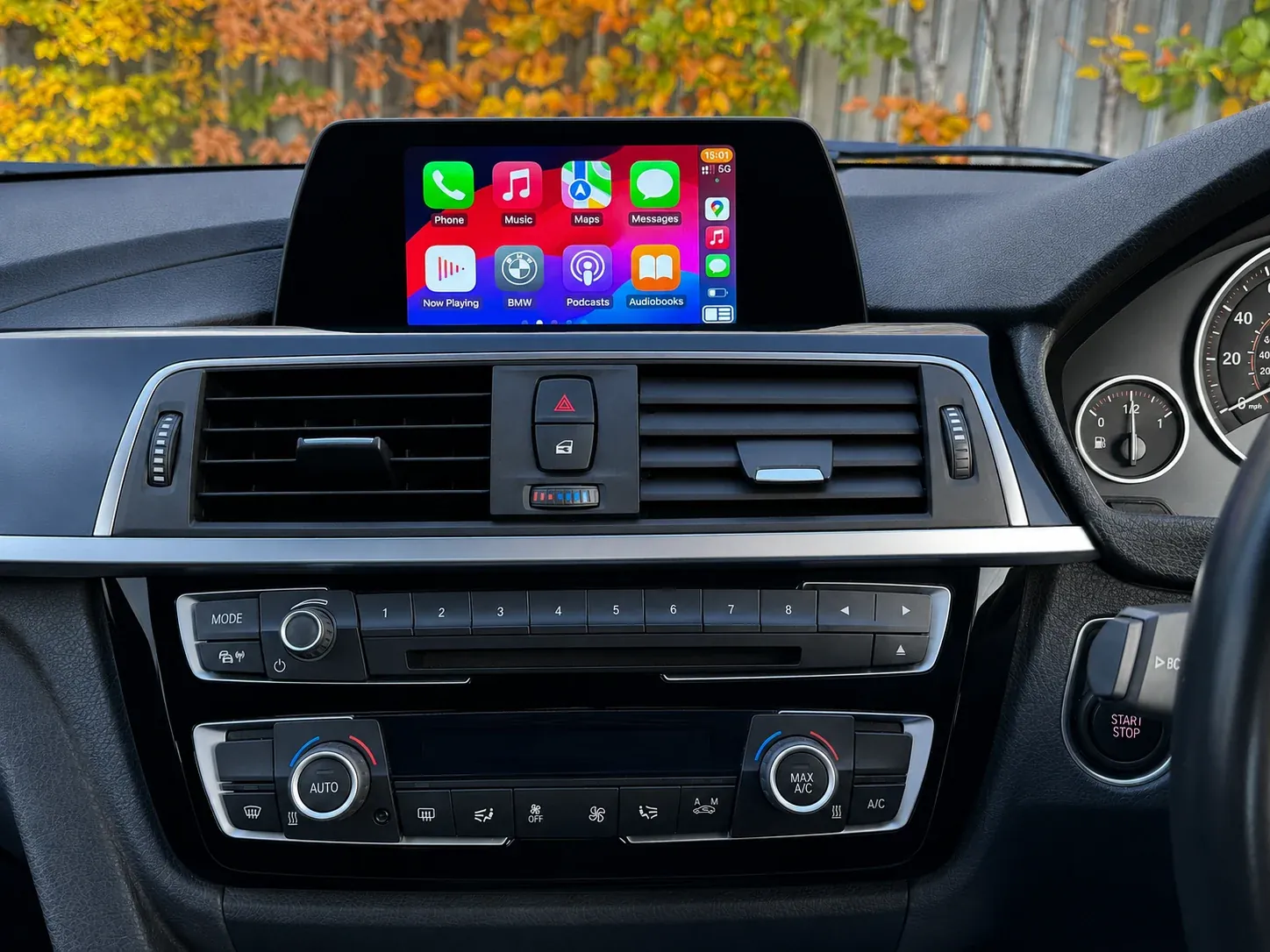 Apple CarPlay running on the same BMW factory screen after activation, dashboard unchanged