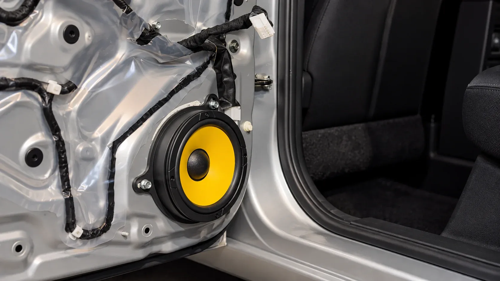 New car door speaker mounted on a custom adapter during installation at Radio King Dublin