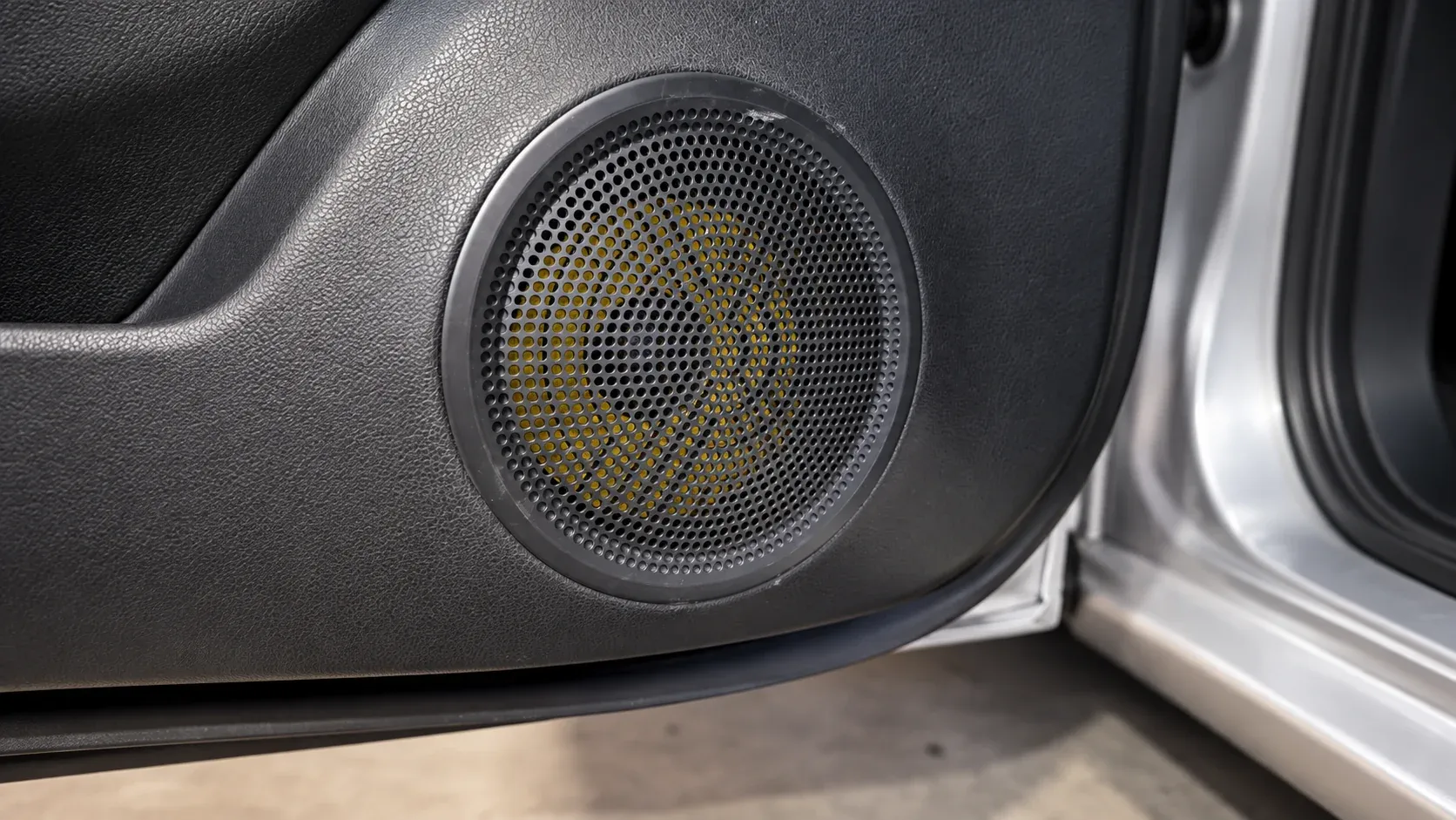 Upgraded car door speaker behind a factory-style grille, fitted by Radio King in Dublin