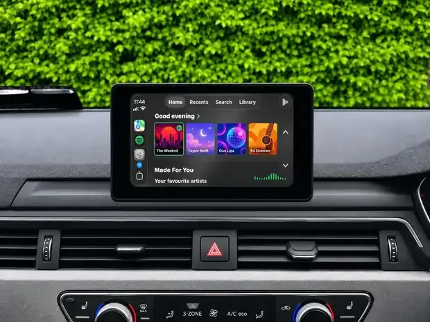 Spotify running on an Apple CarPlay screen with playlists and playback controls