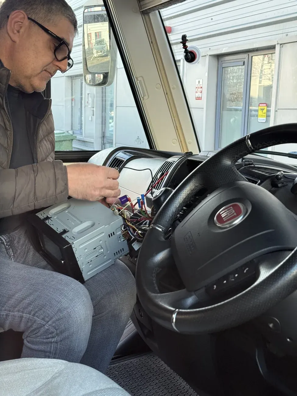 Radio King technician working on the Fiat Ducato camper van wiring loom during a head unit installation in Dublin