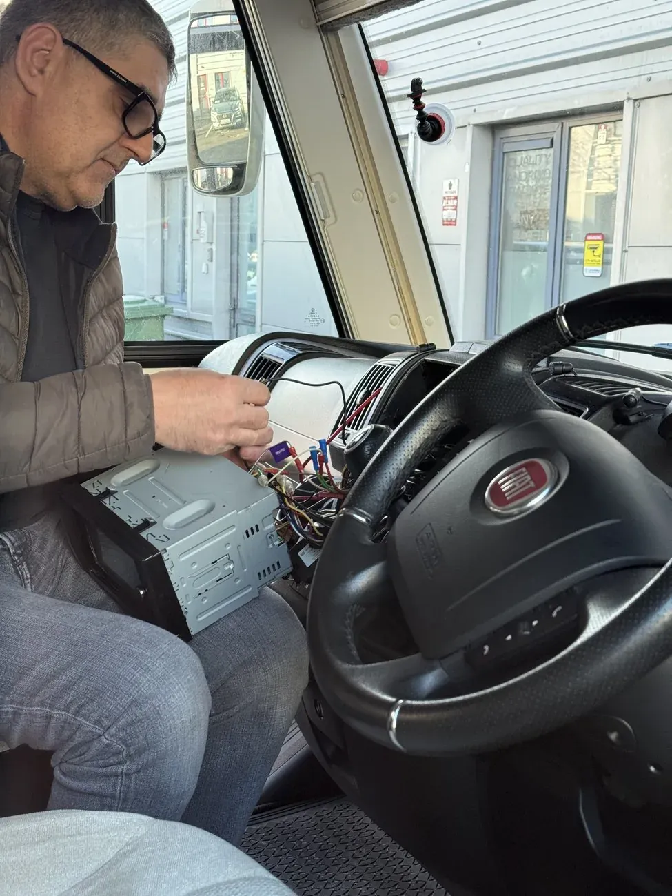 Radio King technician working on the Fiat Ducato camper van wiring loom during a head unit installation in Dublin