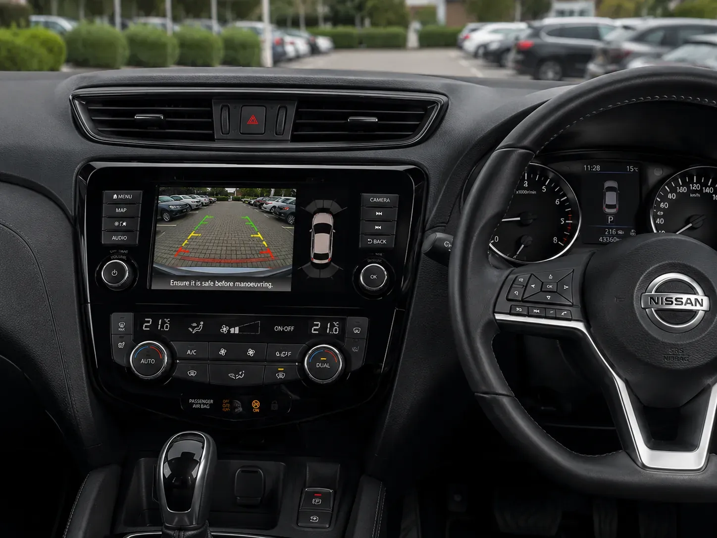 Nissan Qashqai reverse camera view with guidelines on the factory infotainment screen
