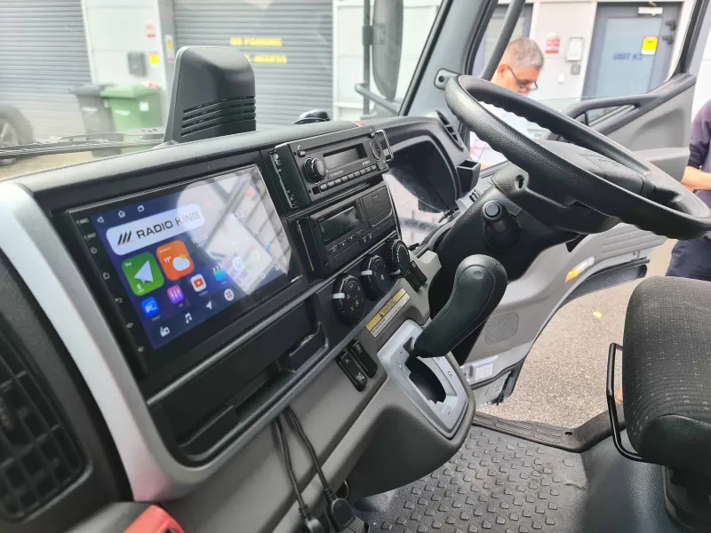 Truck cab with a Radio King Android head unit fitted next to the original radio